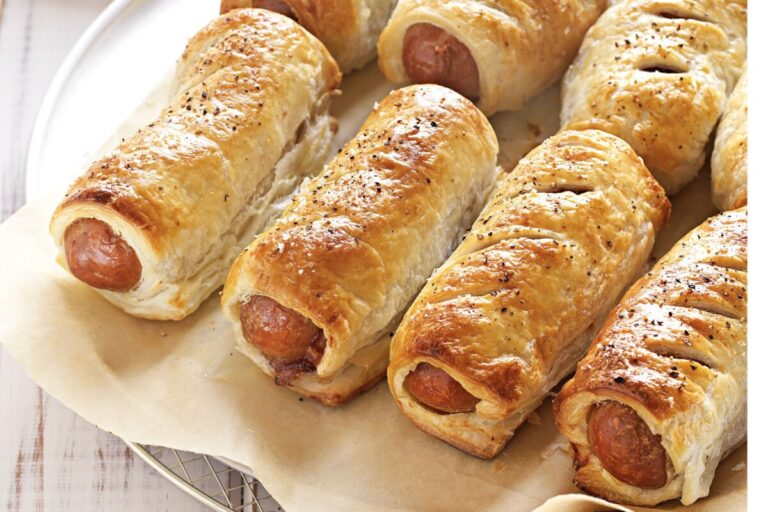 Freshly baked Gluten Free Sausage Rolls on a plate.